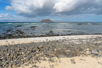 Rocky volcanic coast of Fuerteventura in Corralejo
