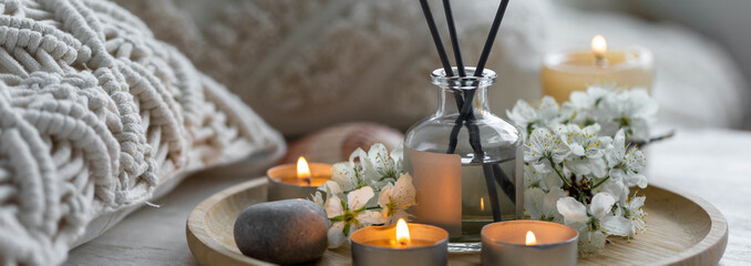 Aromatherapy, cozy atmosphere. Home perfume in glass bottle with wooden sticks, scented burning...