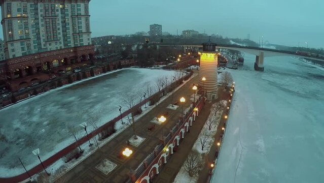 City traffic on Stroginsky bridge near lighthouse on quay 