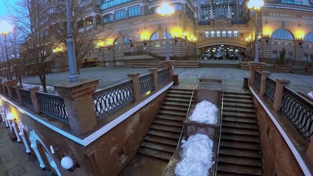 Staircase with lights near dwelling house at winter evening. 
