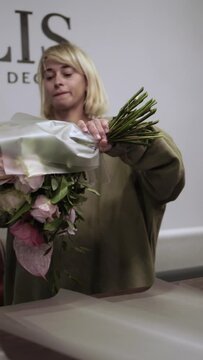 Florist girl works in flower shop Elya