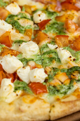 pizza using a large number of different ingredients close-up