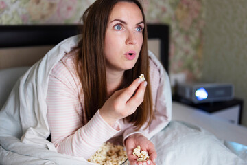 Woman Eating Popcorn Watching Movie at Home