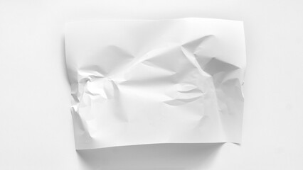 A slightly crumpled sheet of paper close-up with copy space. A white sheet of paper is slightly wrinkled and lies on a white background. Mockup for inscriptions, words, graphics.