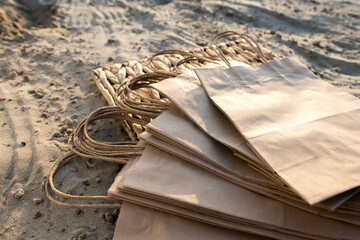 kraft bags lie on the beach. place for text