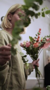 Florist girl works in flower shop Elya