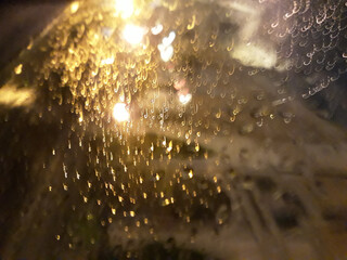 Abstract pictures of the architecture of Vilnius are made on a rainy evening in the car at speed. Raindrops and light play
