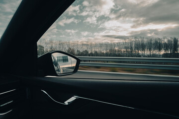 Right side window view scene of a road car on a highway on a beautiful forest landscape