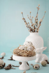 easter and quail eggs decoration on pastel blue background