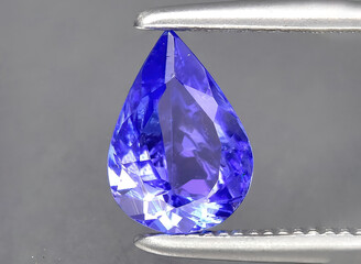 natural blue tanzanite gem on the background