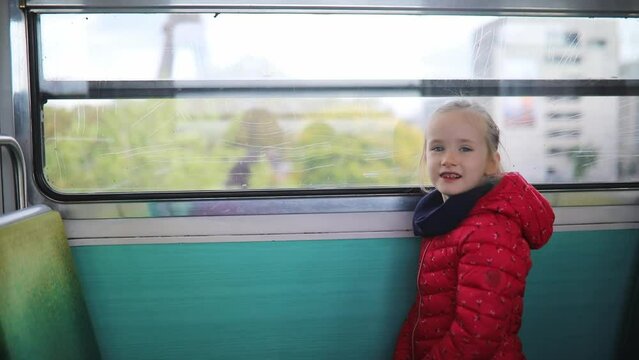 Adorable preschooler girl travelling in a train of Parisian underground