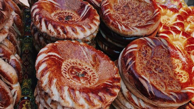 Tortillas on the market in Samarkand, Uzbekistan - June 29, 2023: Goods and traders at the Oriental Bazaar in Uzbekistan. Siab Bazaar is the largest and oldest bazaar in Samarkand. 4K