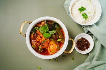 Spicy Chinese style sichuan fish hot pot served with jasmine rice