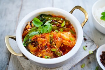 Spicy Chinese style sichuan fish hot pot served with jasmine rice