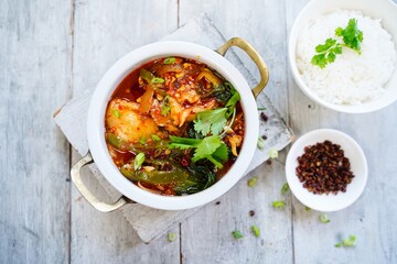 Spicy Chinese style sichuan fish hot pot served with jasmine rice