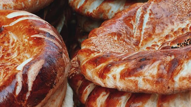 Tortillas on the market in Samarkand, Uzbekistan - June 29, 2023: Goods and traders at the Oriental Bazaar in Uzbekistan. Siab Bazaar is the largest and oldest bazaar in Samarkand. 4K