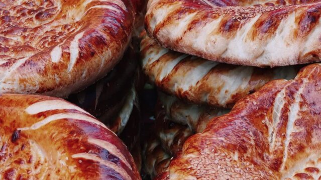 Tortillas on the market in Samarkand, Uzbekistan - June 29, 2023: Goods and traders at the Oriental Bazaar in Uzbekistan. Siab Bazaar is the largest and oldest bazaar in Samarkand. 4K
