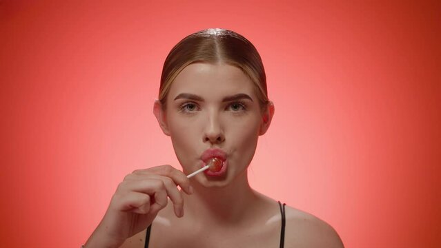 Woman licking lollipop