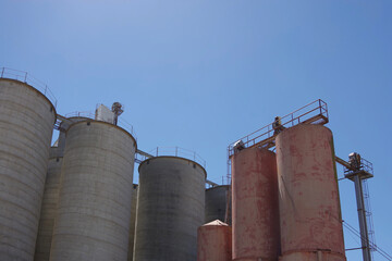Large agriculture silos under blue sky