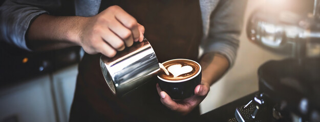 Artisan Creates Heart in Coffee Foam. Skilled hands of barista pouring steamed milk into a rich espresso, art and precision involved in preparing a classic caffeinated beverage.