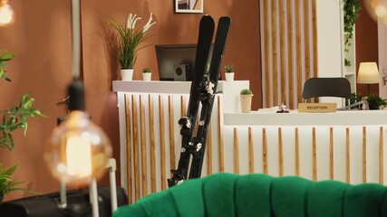 Winter sports equipment including skis and snowboards at vacant premium alpine complex. Lovers of...