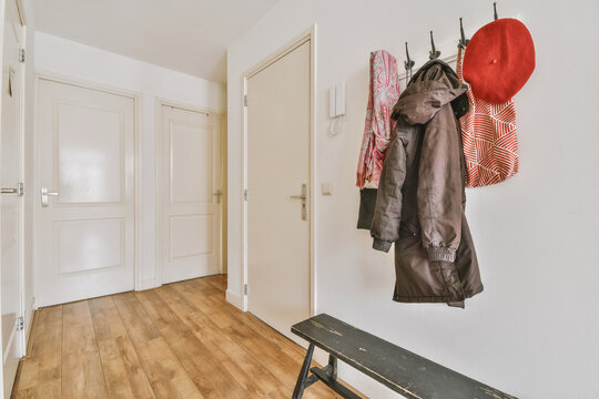 Cozy home entrance with wooden bench and clothing