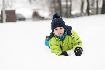 Fototapeta na wymiar Young Boy Enjoying Himself in the Snow