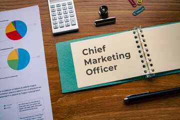 There is notebook with the word Chief Marketing Officer. It is as an eye-catching image.