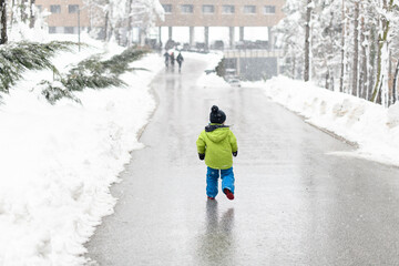 Fototapeta na wymiar Happy Little Kid is Playing on Winter Day