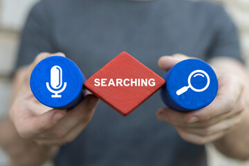 Man holding colored blocks sees word: SEARCHING. Search information and web navigation business...