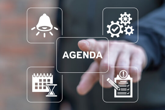 Man using virtual touchscreen sees word: AGENDA. Agenda Meeting Appointment Activity Information Business concept. Planner, calendar activities and tasks.