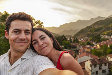 Couple self-potrait in a small village in mountain valley. Rural tourism and nature concept. Spain.