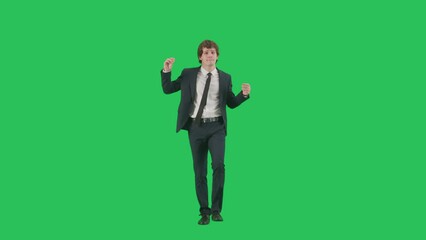 Portrait of male model in suit on chroma key green screen background. Friendly young businessman in trendy suit walking smiling dancing at camera. - Powered by Adobe