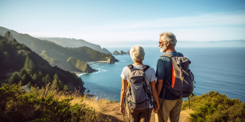 Senior couple admiring the scenic Pacific coast while hiking, filled with wonder at the beauty of nature during their active retirement. Exploring the great outdoors in the mountains, active lifestyle