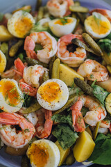 salad with hardboiled eggs, shrimp, pickles, butter lettuce, fennel bulb