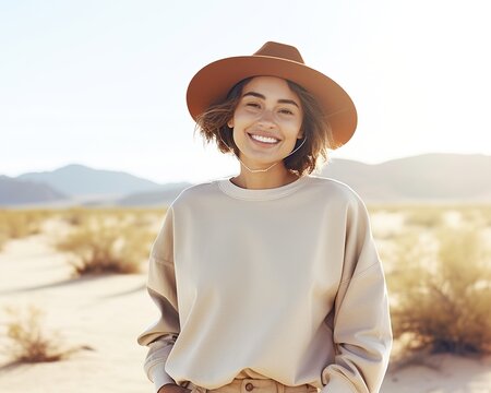 Smiling woman wearing a hat in the desert
