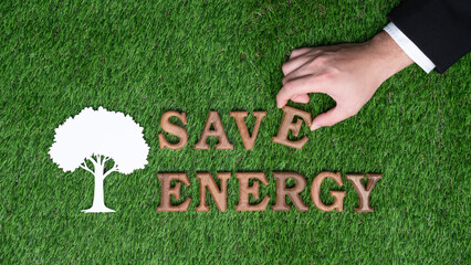 Hand arrange wooden alphabet in ECO awareness campaign on biophilia green grass background o...