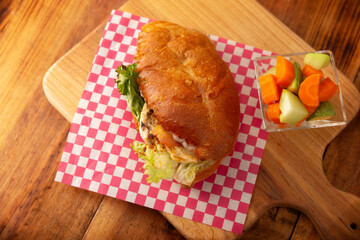 Healthy homemade grilled chicken breast sandwich with mayonnaise, lettuce, tomato and other vegetables and ingredients. Table topview.