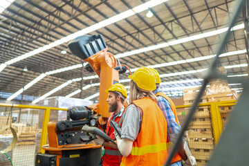 team Engineers standing by robotic arm and operating machine in factory. worker man control on tablet. Workers work at heavy machine robot arm. High-tech robot with a remote system in Wood factory.