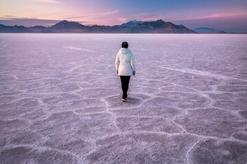 Woman on salt flats at sunset. Bonneville Salt Flats. Salt Lake City. Utah. USA 