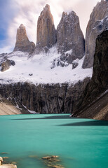 las torres covered by snow with blue lake at the front © Yan