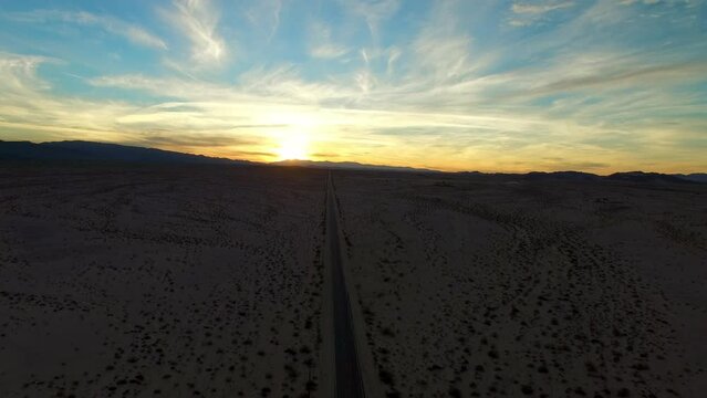 Aerial Scenic View Of Tranquil Semi Arid Desert, Drone Flying Backwards During Sunset - Palm Springs, California