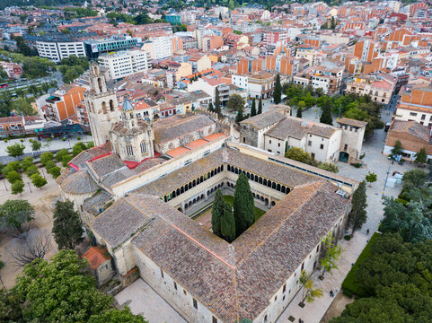View from drone of cityscape of Sant Cugat del Valles with ancient Monastery in summer day, Spain.