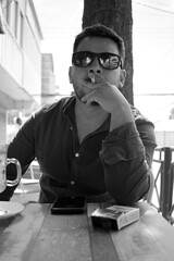 man smoking a cigarette, black and white photography