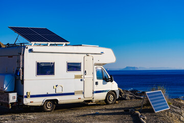 Caravan with tilt solar panels on roof.