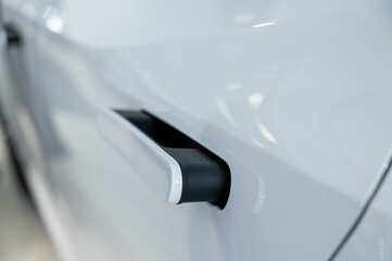 Close-up of an integrated handle in a car door. Fingerprint lock. 
