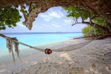 Empty hammock at the beach on a tropical island, Maldives