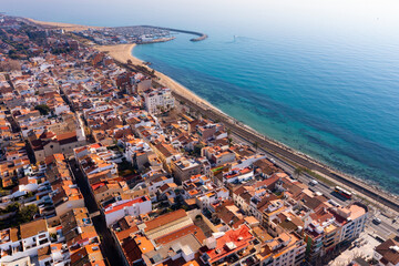 Aerial photo of Premia de Mar with view of residential buildings along Mediterranean Sea coast, Catalonia, Spain. - obrazy, fototapety, plakaty
