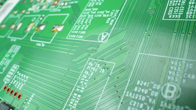 A Printed Circuit Board (PCB) is a vital electronic component, featuring interconnected conductive pathways. It facilitates electronic device functionality. Video footage. Innovation concept.
