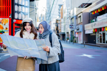 woman girl tourist Two Asian friends but different religions, one of whom is a Muslim girl. Looking...